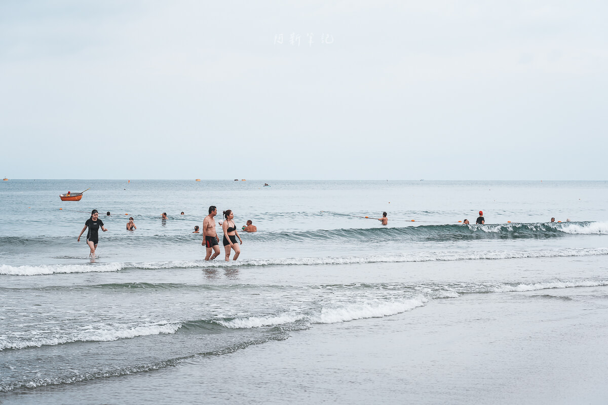 峴港海灘的海浪、沙灘與在水邊活動的遊客