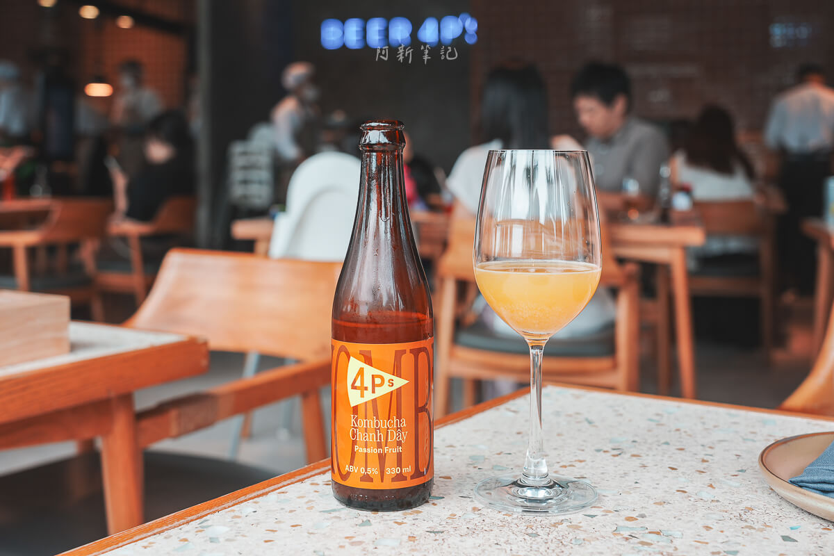 峴港 Pizza 4P's Indochina 桌上的 4P's 百香果康普茶瓶子與高腳杯